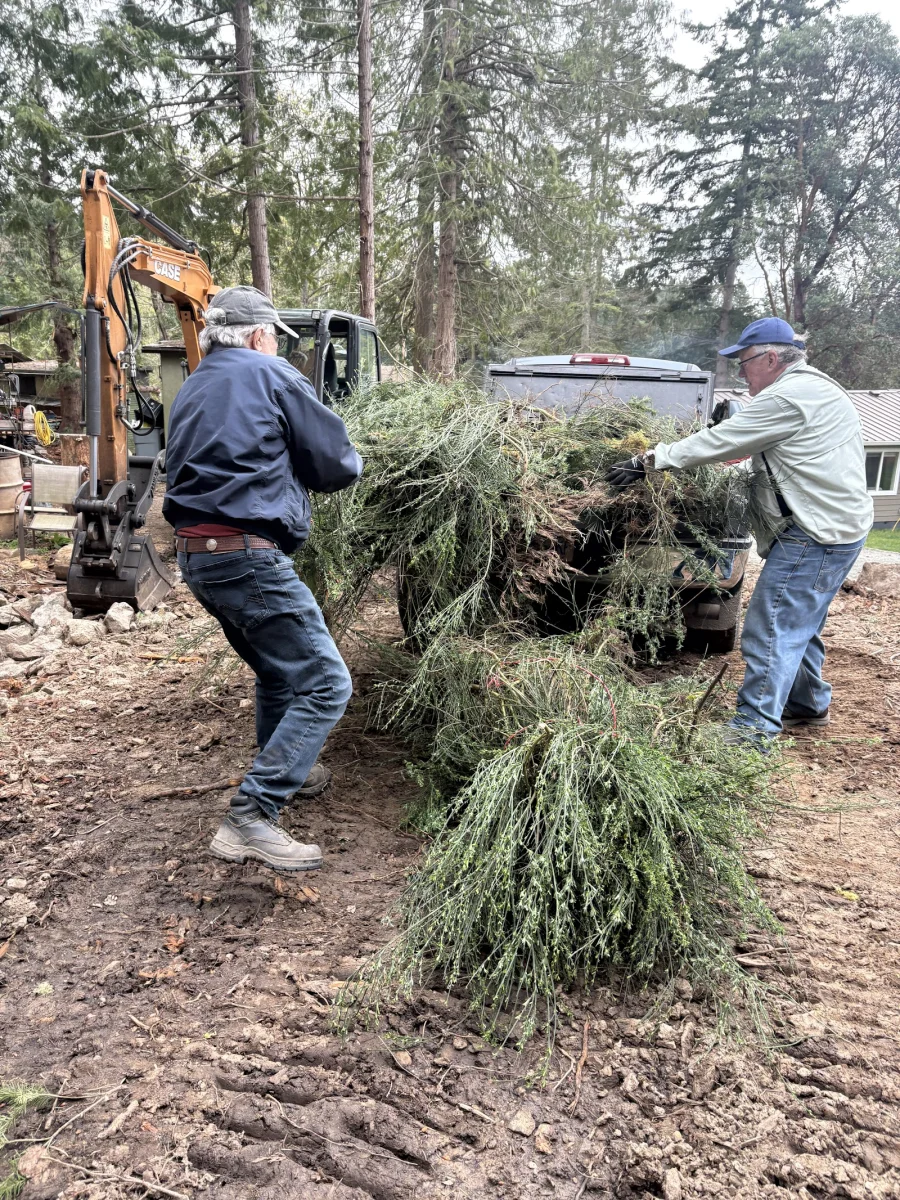 Ron Bertrand and Jeff Pallister unloading a truck load of broom.jpeg